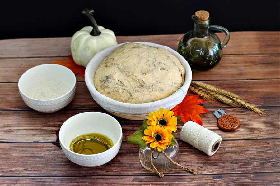 image of pumpkin shaped pumpkin spice sourdough bread ingredients needed to tie up and shape the bread before baking