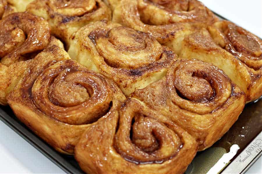 entire tray of warm baked cinnamon rolls with gooey glaze