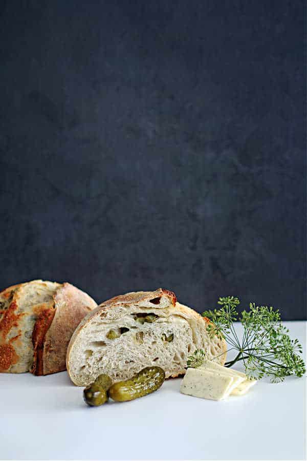 picture of a cut up round sourdough bread with havarti cheese and dill inclusions