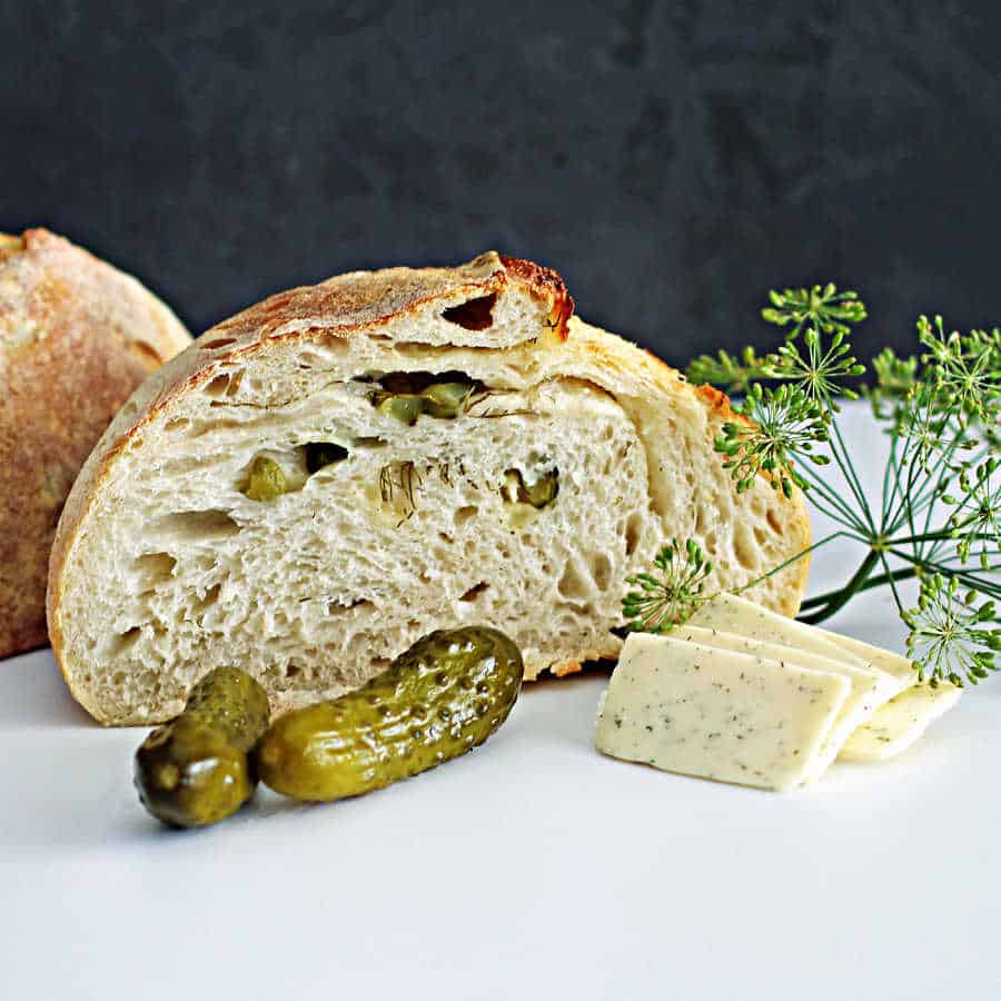 sourdough havarti and dill bread cut in half with dill pickles and havarti cheese from the Sour Strawberry Blog