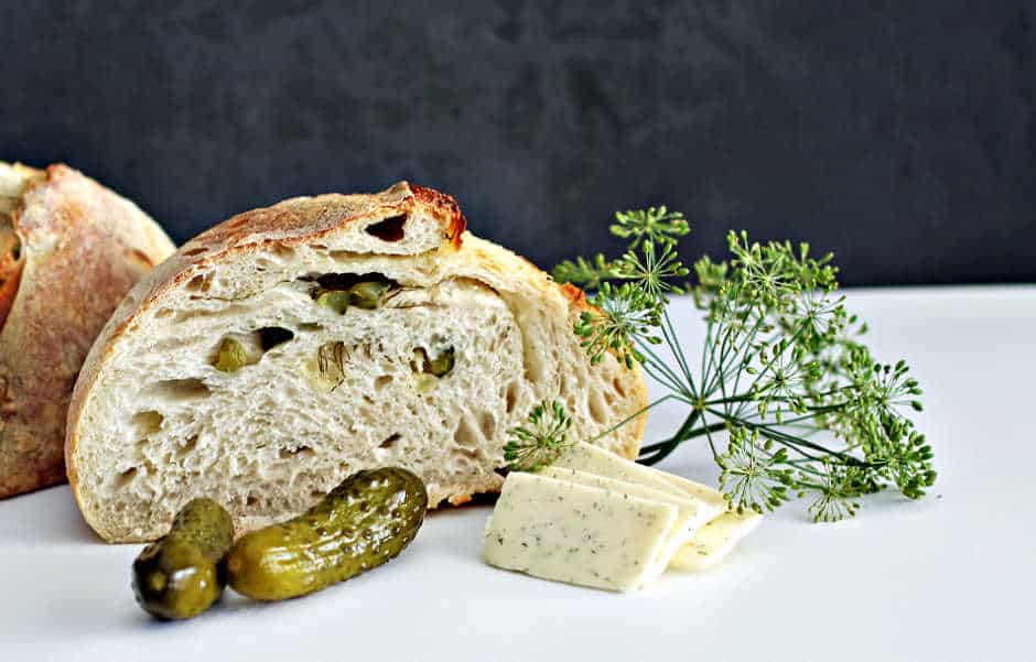 sourdough havarti and dill bread cut in half with dill pickles and havarti cheese from the Sour Strawberry Blog