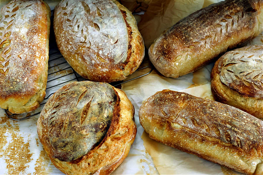 selection of baked sourdough loaves on top of parchment paper from the sour strawberry