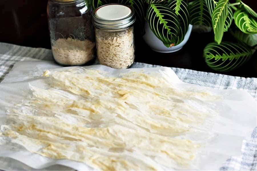 picture of dried sourdough starter sitting on top of a piece of parchment paper